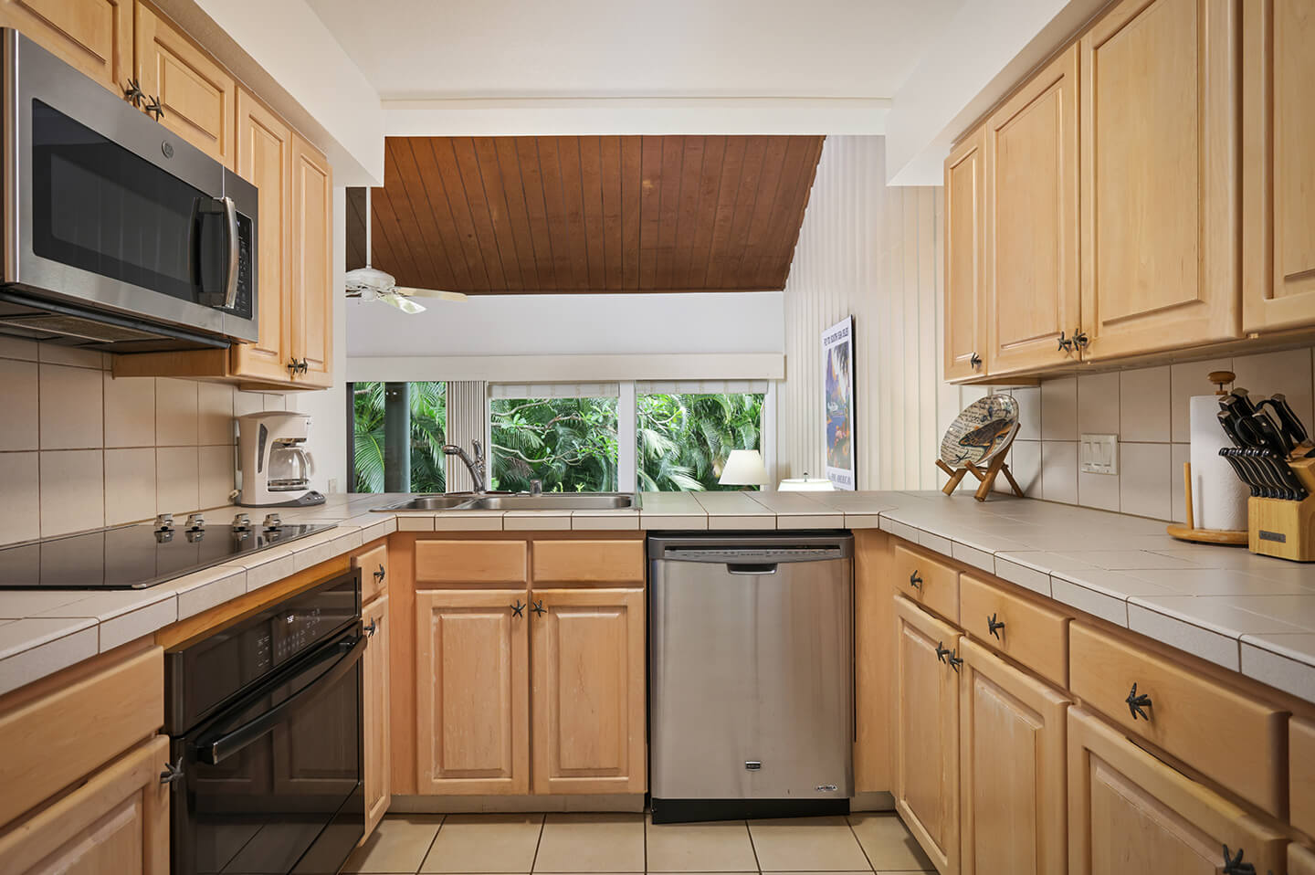 Kitchen stove, microwave, dishwasher, sink, counters, and cabinets.