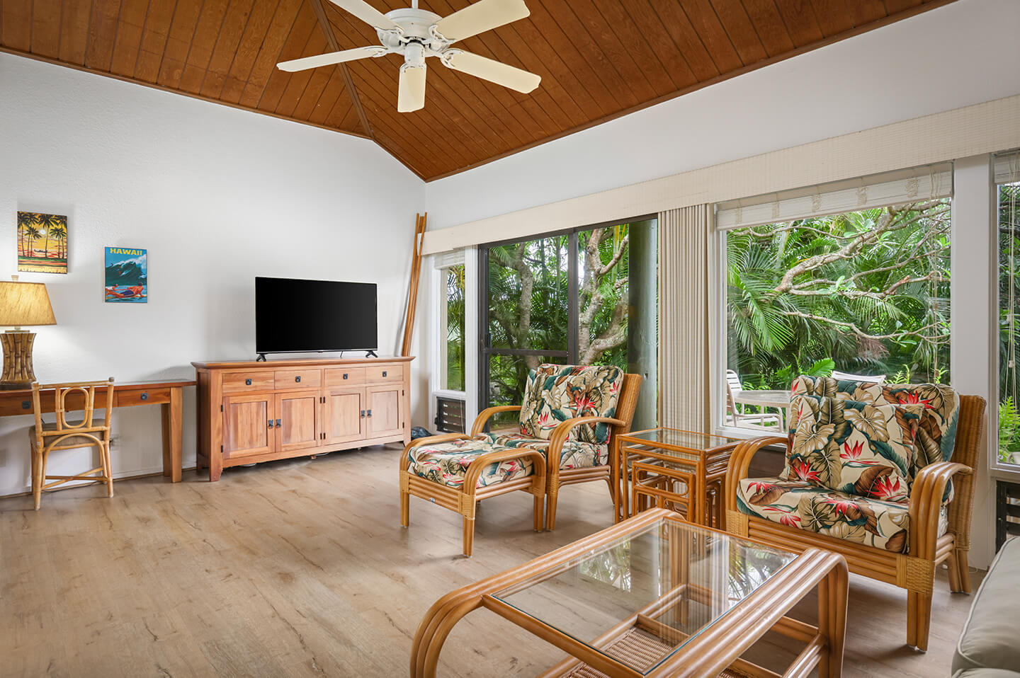 Living room with seating, table, TV, and patio.