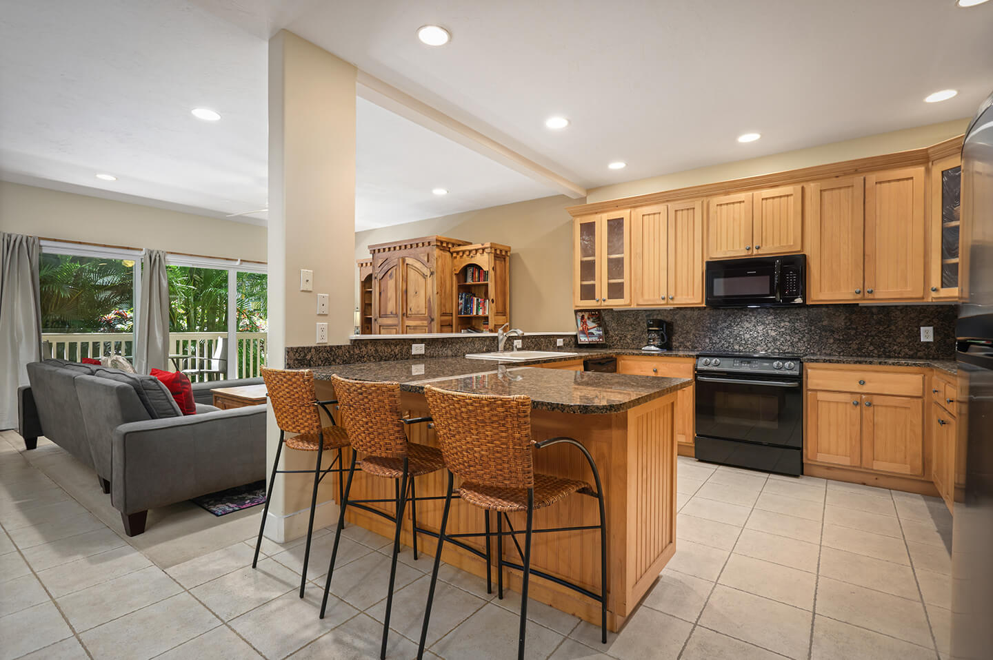 Kitchen with counter seating and living area with couch.