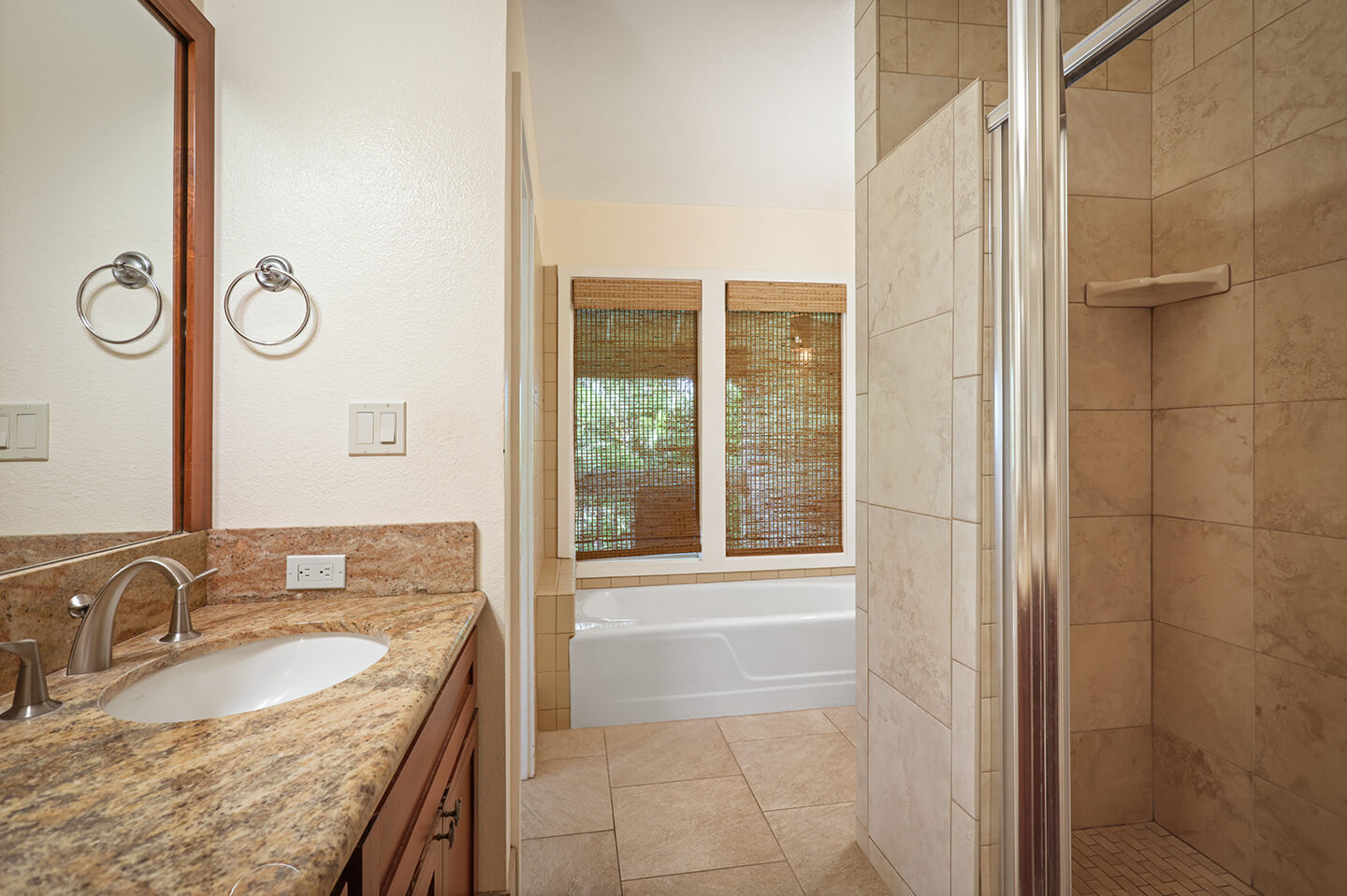 Bathroom with counter, sink, shower and tub.