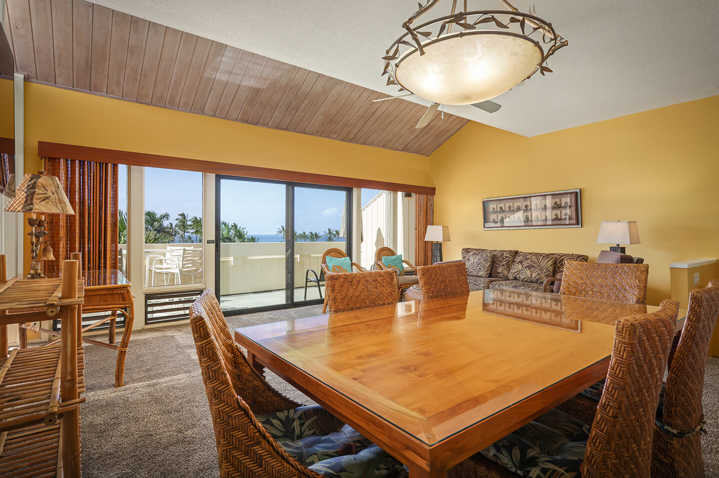 Dining area with table, chairs, living area and patio.