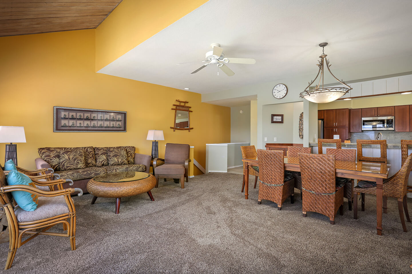 Living area with couch, table, seating and dining area with table and chairs.