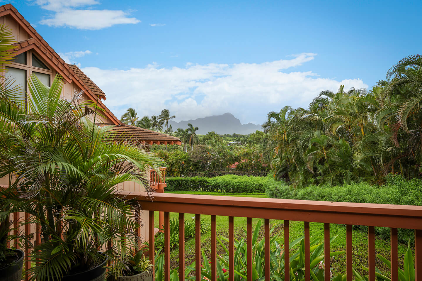Balcony view of gardens and mountain.