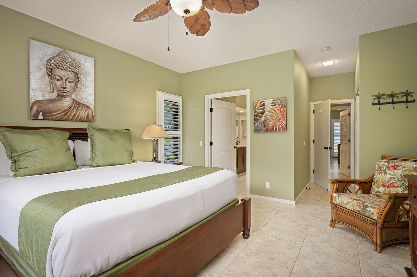 Room with bed, chair, lamp, private bath.