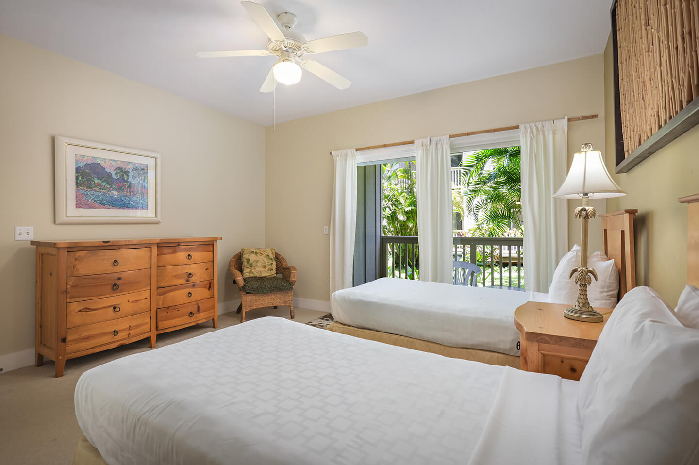 Room with 2 beds, dresser, night stand, lamps, chair, patio.