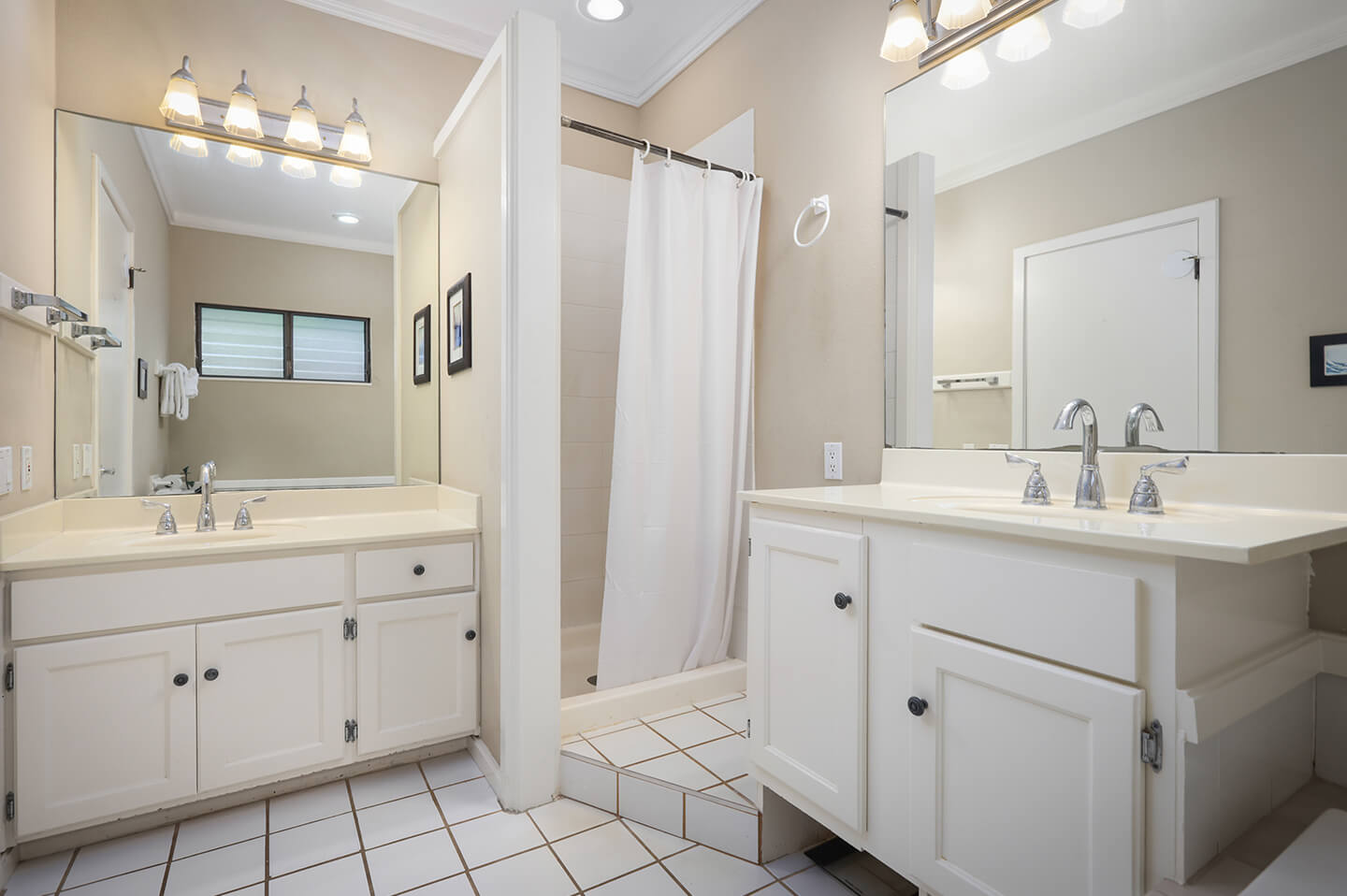 Bathroom with 2 sinks and shower.
