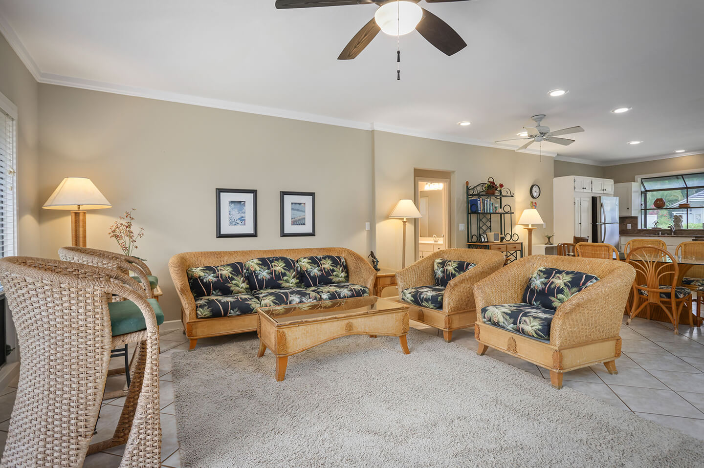 Living area with chouch, seating, table, lamps.
