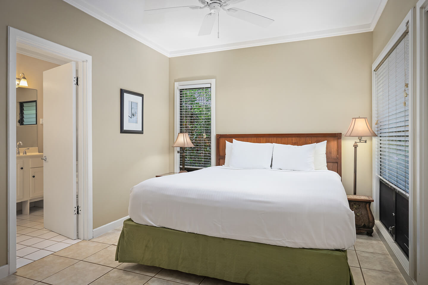 Room with bed, lamps, private bath.