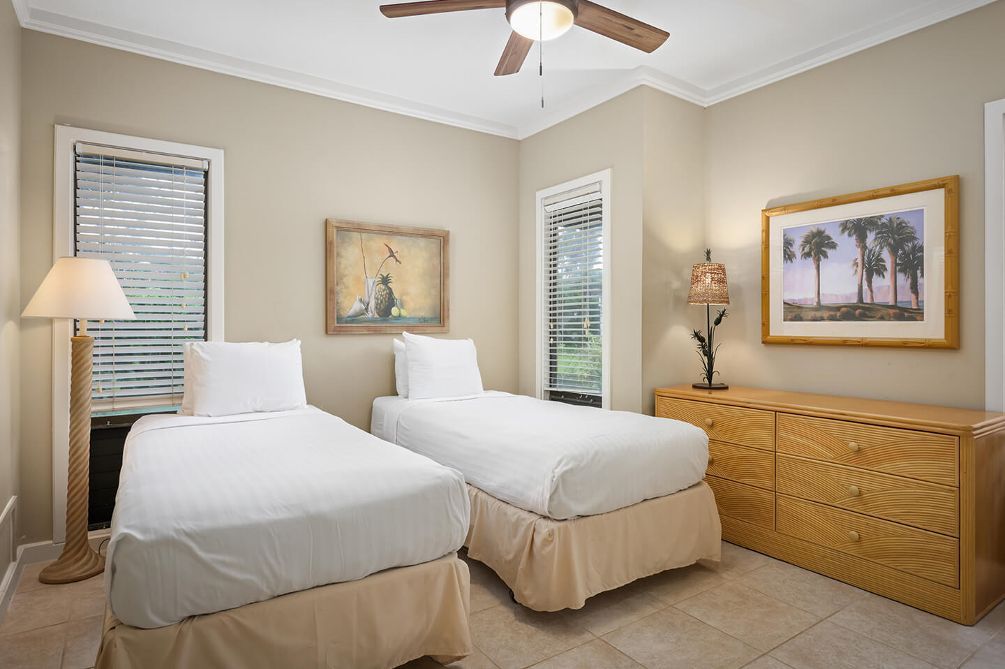 Room with 2 beds, lamps, dresser.