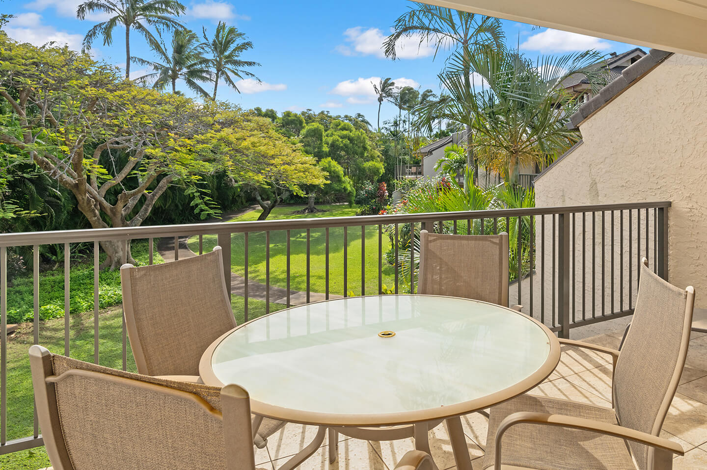 Patio with garden view, table, and chairs.