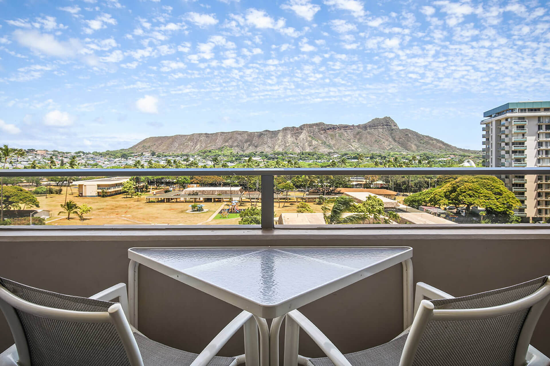 Balcony with table, chairs, and full view of Diamond Head.