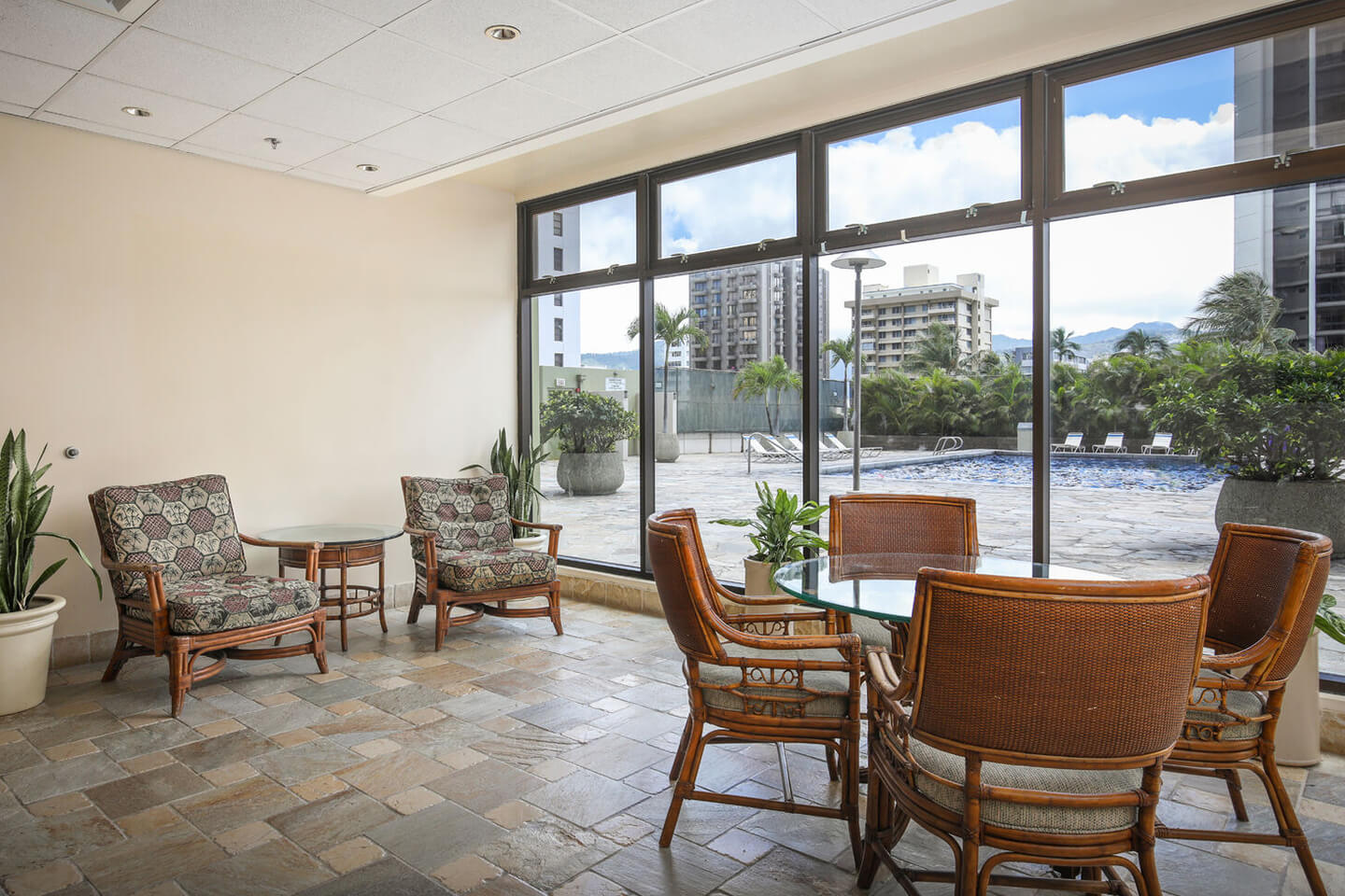 Hospitality room with seating, tables, and large picture windows with view of deck.