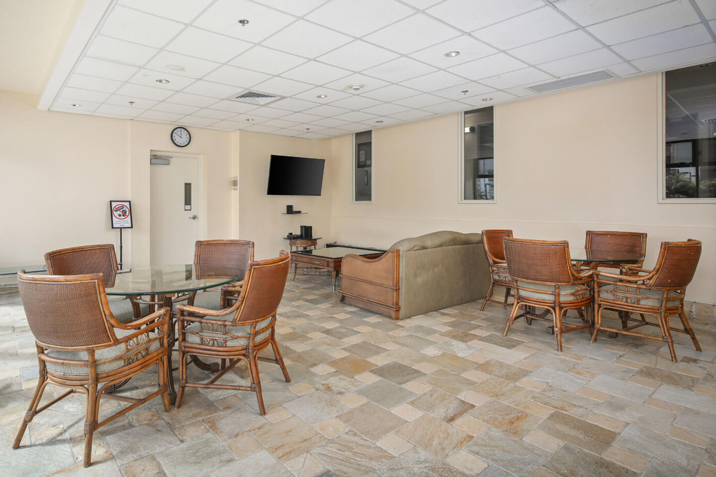 Hospitality room with seating, tables, and TV.