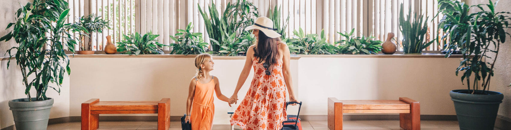 Young girl and her mother at the swimming pool and sun deck area at the Aston Waikiki Sunset 