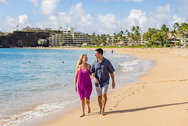 Couple walking on the beach.