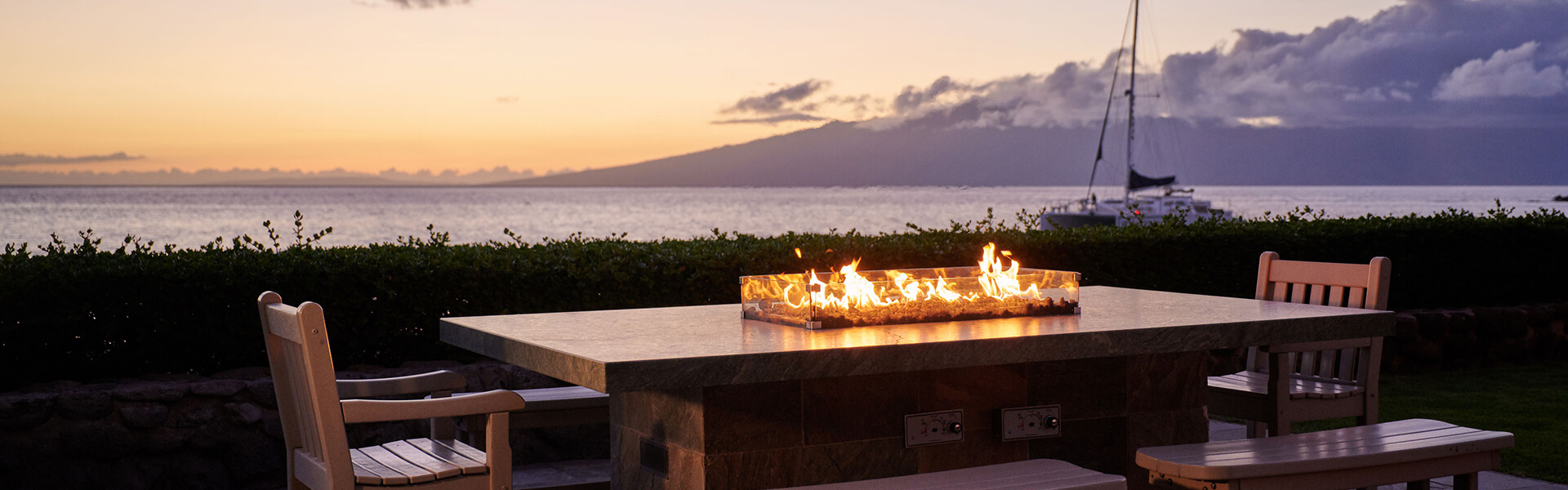 Beachfront fire pit at sunset.