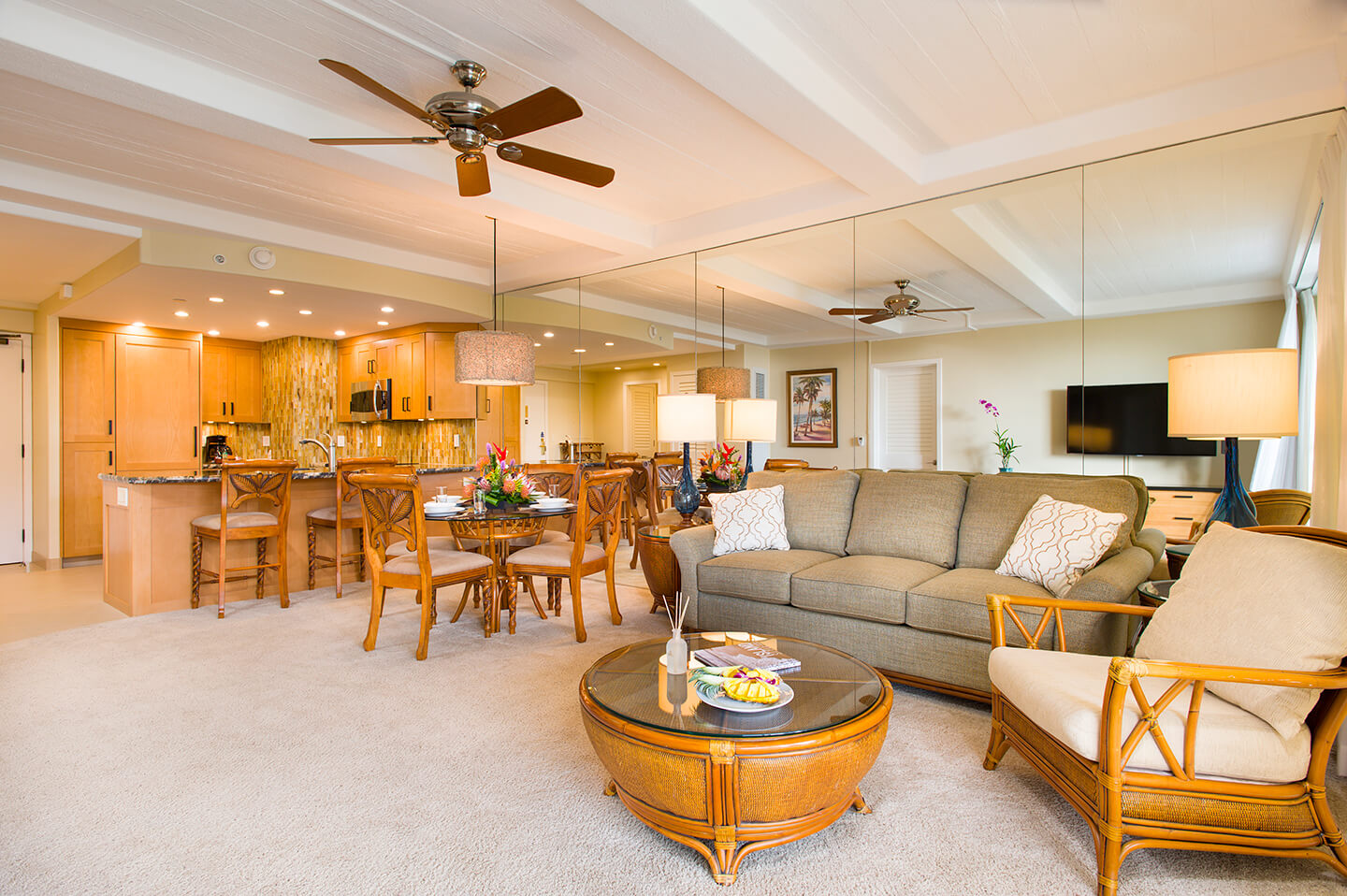 Living area with a couch, coffee table, TV, dining area, and kitchen.