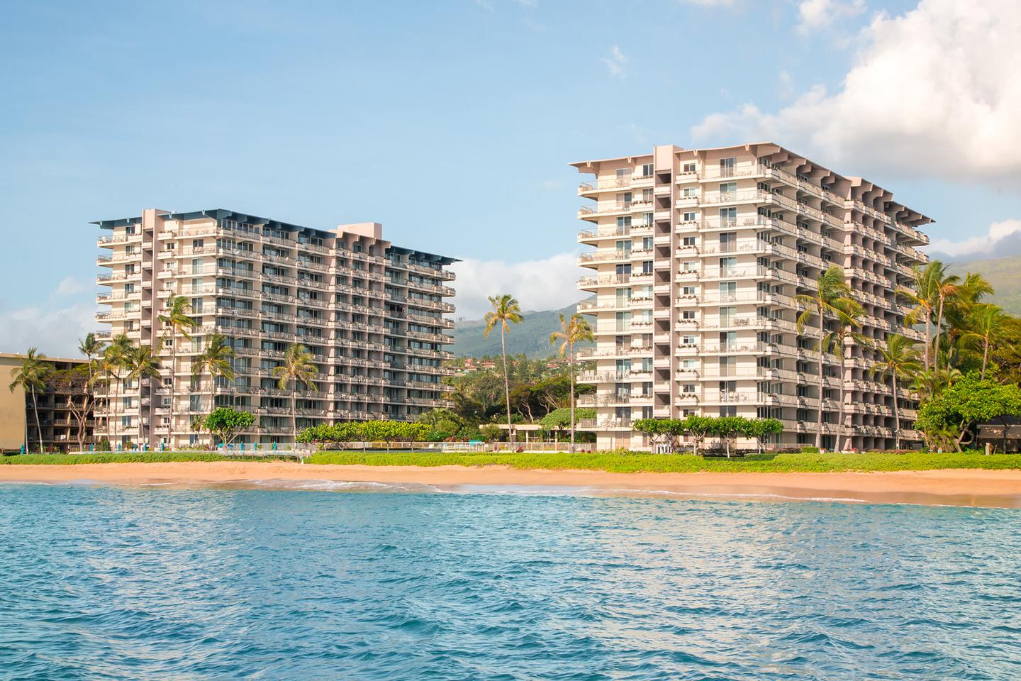 Resort exteriors on sandy beachfront.