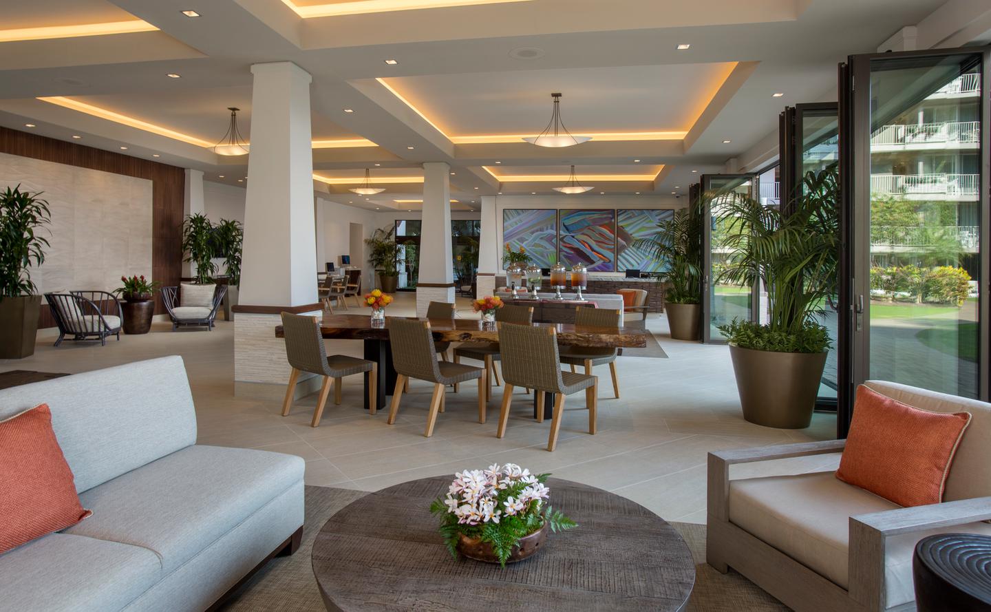 Open-air lobby area with couches, seating, tables.
