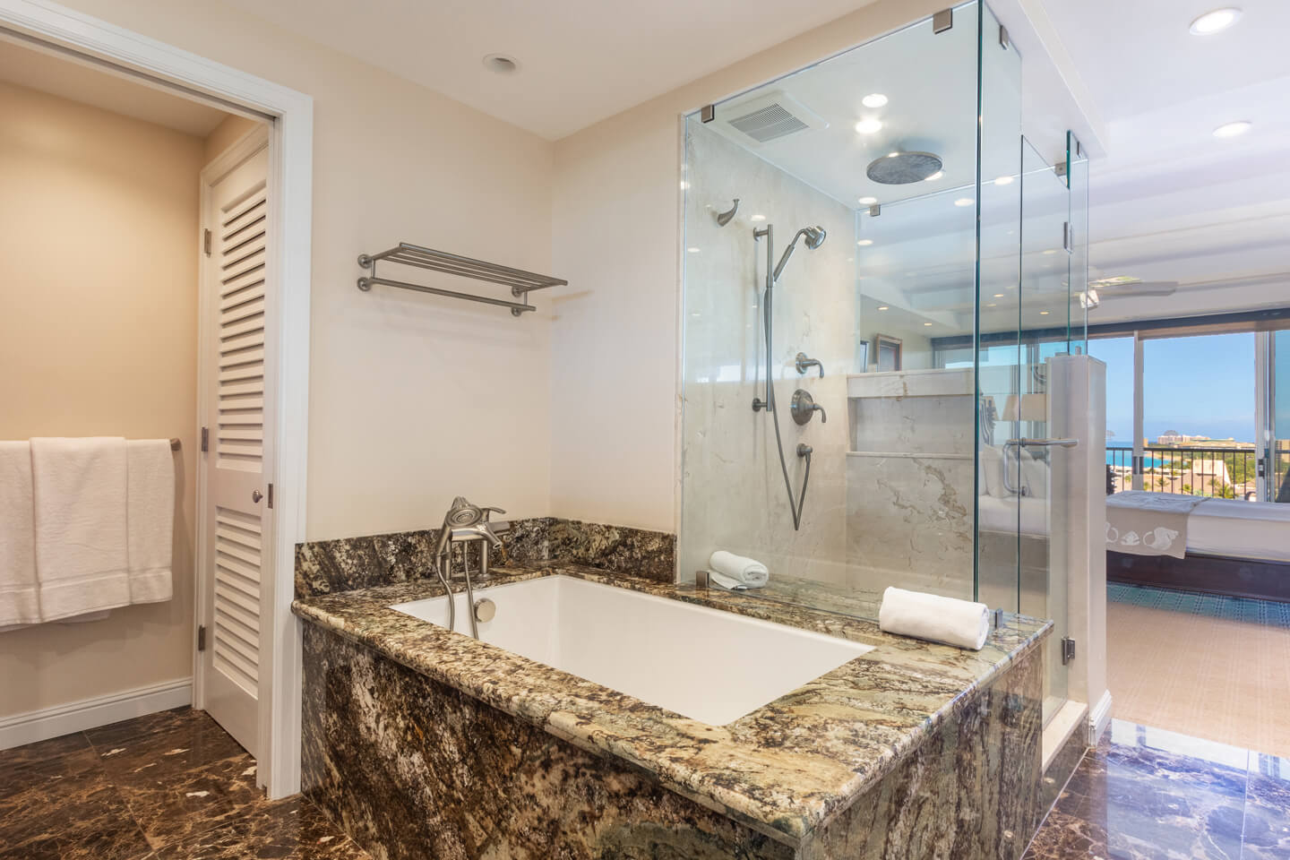 Bathroom with deep soaking tub and glassed shower.