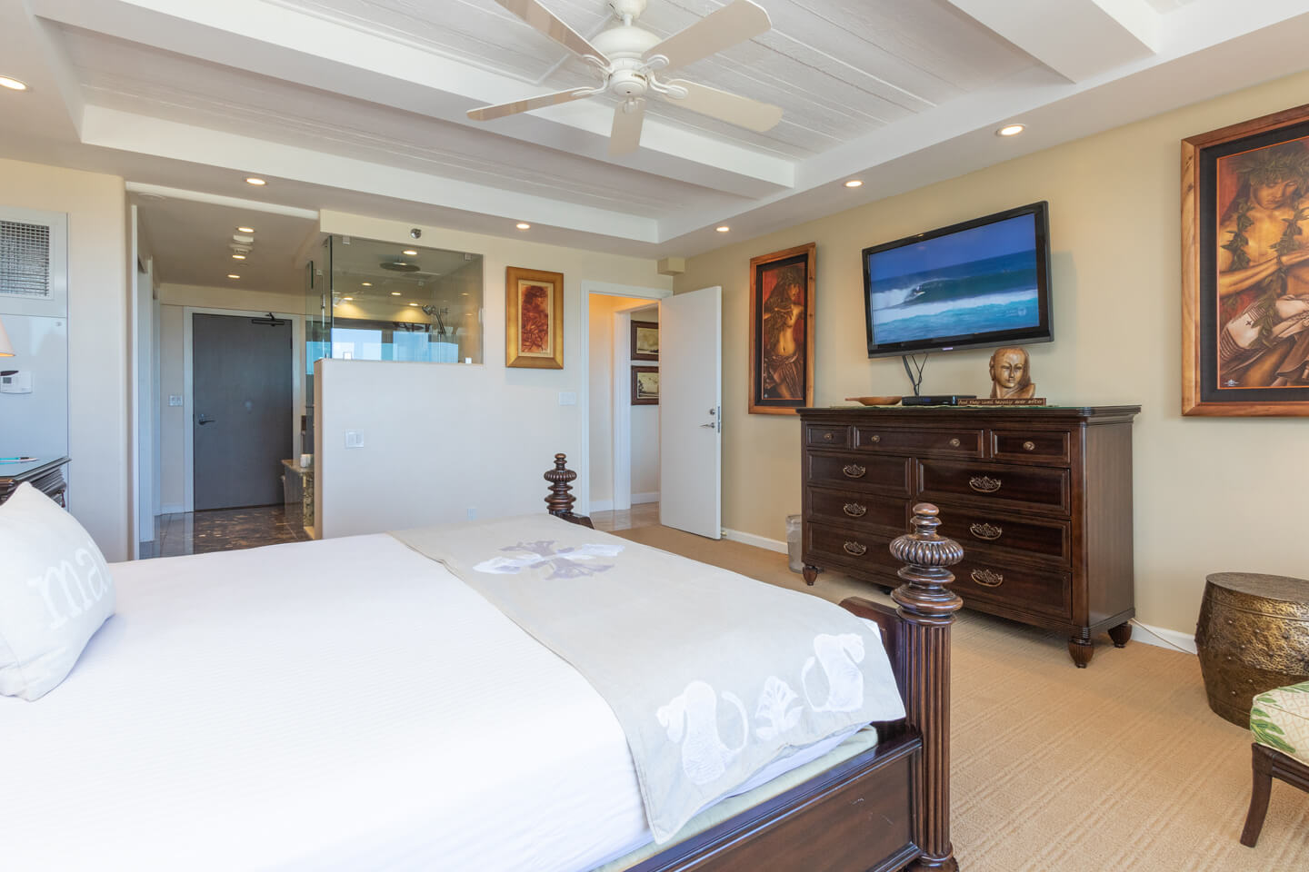 Room with a bed, dresser, and TV.
