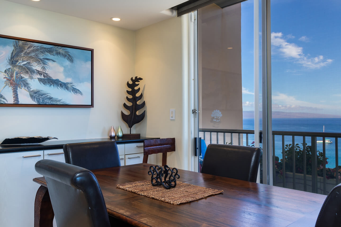 Dining area with a table, chairs, and buffet counter.