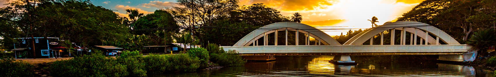 Bridge over river at sunset hour