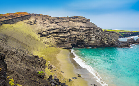 View of a green sand beach and bay