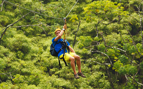 Man ziplining through the trees