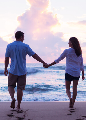 couple smiling with a waterfall in the background